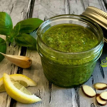 Basil Pesto is bursting with the flavors of extra virgin olive oil, fresh basil leaves from my garden, Parmesan cheese for texture and saltiness, lemon juice and zest for a bright note and the unexpected nuttiness of toasted almonds. #pesto #summer #summerrecipe #easyrecipe #basil #almonds #farmersmarket #swirlsofflavor