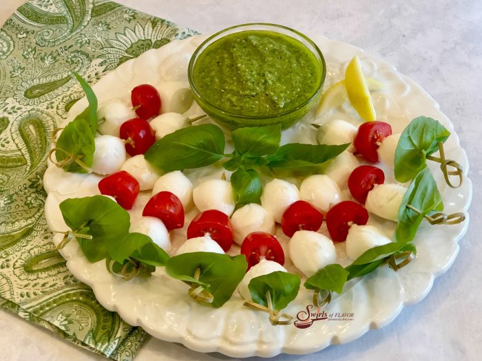 Caprese Skewers With Pesto, a simple homemade pesto dipping sauce with skewers of fresh basil, mozzarella and tomatoes, is the perfect indulgence when you unwind after a busy week. 