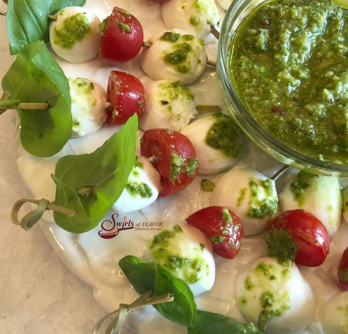 Caprese Skewers With Pesto, a simple homemade pesto dipping sauce with skewers of fresh basil, mozzarella and tomatoes, is the perfect indulgence when you unwind after a busy week. 