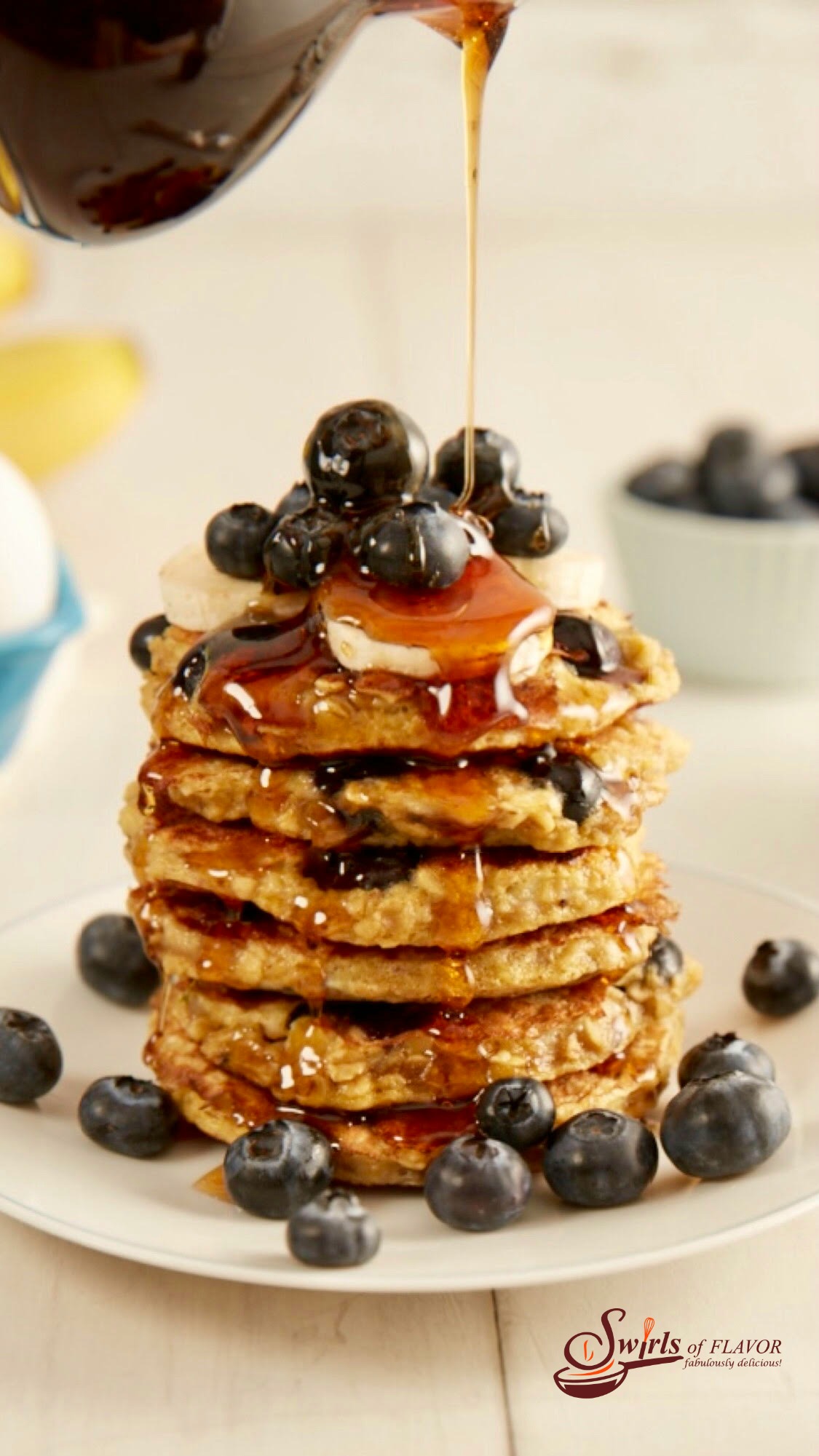 stack of gluten free blueberry pancake recipe with syrup pouring over