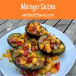 grilled avocados topped with mango salsa and text overlay