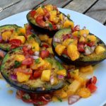 Grilled Avocados With Mango Salsa is an easy recipe for lightly seasoned avocados grilled to perfection and topped with a homemade lime-kissed mango salsa.