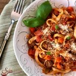 One Pot Fettuccine Bolognese is an easy recipe brimming with beef, carrots, celery and onions and forms a sauce with diced tomatoes, tomato sauce, red wine and seasonings as it cooks with the pasta in the same pot. Perfect pasta and sauce recipe for a busy weeknight dinner and great to serve for company! #easyrecipe #onepot #onepotpasta #pastarecipe #weeknightdinner #kidfrienldy #groundbeefsauce #pastasauce #swirlsofflavor