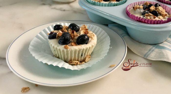 Made with fresh blueberries, yogurt and granola, Triple Citrus Blueberry Frozen Yogurt Cups are a refreshing and nutritious frozen snack, dessert or breakfast and the perfect way to cool off on a hot day. #blueberries #granola #Greekyogurt #frozendessert #snack #funforkids #kidfriendly #easyrecipe #summer #breakfast #brunch #swirlsofflavor