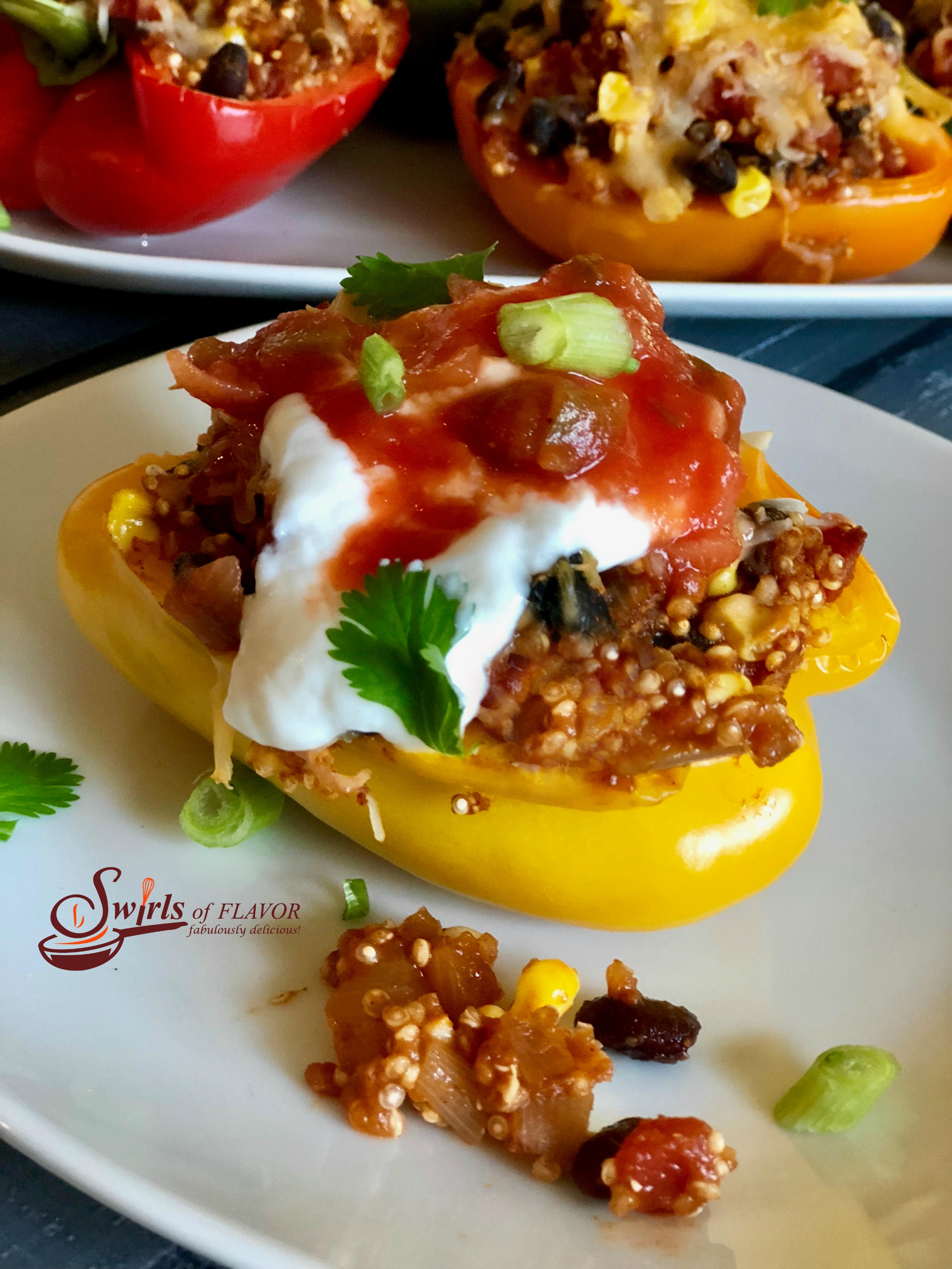 Mexican Quinoa Stuffed Peppers is an easy recipe that's perfect for a weeknight dinner and beautiful enough to serve to guests. Stuffed peppers take on a Mexican flair, bursting with a filling of quinoa, black beans, corn, tomatoes and salsa. #peppers #stuffedpeppers #quinoa #quinoastuffedpeppers #blackbeans #corn #easyrecipe #dinner #weeknightdinner #comfortfood #swirlsofflavor