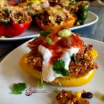 Mexican Quinoa Stuffed Peppers is an easy recipe that's perfect for a weeknight dinner and beautiful enough to serve to guests. Stuffed peppers take on a Mexican flair, bursting with a filling of quinoa, black beans, corn, tomatoes and salsa. #peppers #stuffedpeppers #quinoa #quinoastuffedpeppers #blackbeans #corn #easyrecipe #dinner #weeknightdinner #comfortfood #swirlsofflavor