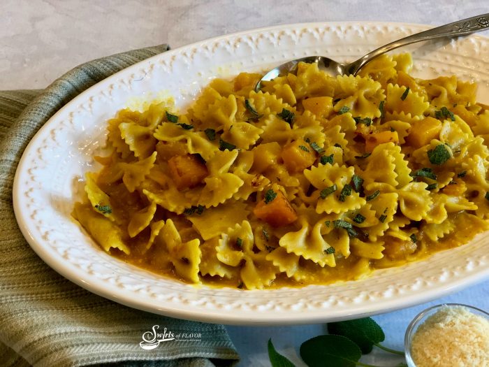 The sweet nutty flavor of butternut squash and fragrant aroma of fresh sage combine with pasta in a light buttery sauce making One Pot Butternut Squash Pasta With Sage your soon-to-be favorite vegetarian one pot dinner. #onepot #pasta #butternutsquash #sage #easyrecipe #dinner #entertaining #meatlessmonday #vegetarian #weeknightdinner #swirlsofflavor