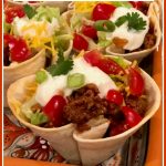 ground beef tacos in tortilla cups with text overlay