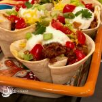 ground beef tacos in tortilla shells with taco toppings
