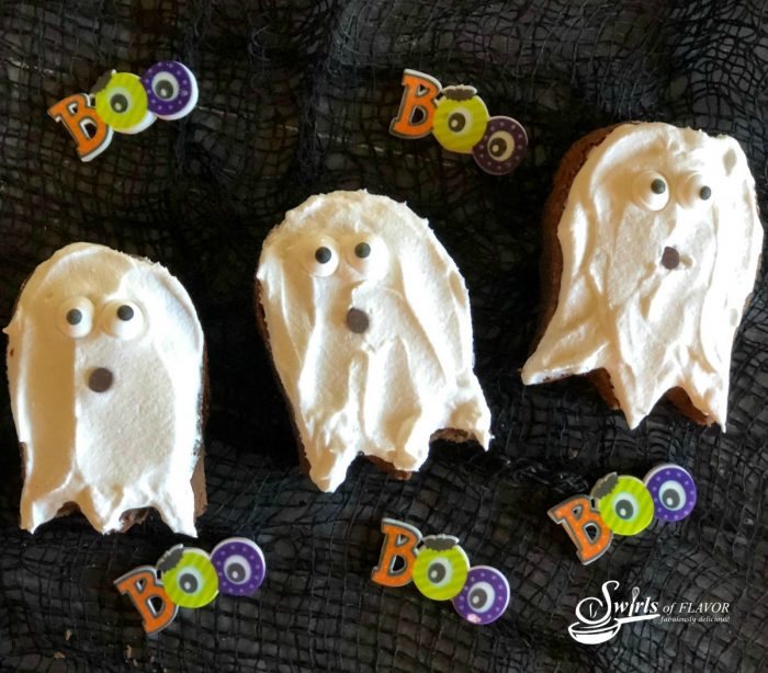three ghost shaped brownies and sugar Boo decorations