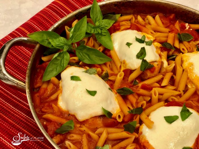 One Pot Chicken Parmesan Pasta is an easy recipe bursting with all the flavors of Chicken Parmesan, seasoned chicken, penne pasta, tomato sauce and cheese, that cook up all together for a quick weeknight dinner that's ready in just 30 minutes! #onepotdinner #chickenparmesan #skilletdinner #pasta #penne #easydinner #weeknightdinner #lessthan30minutes #cheese #onepot #swirlsofflavor                   