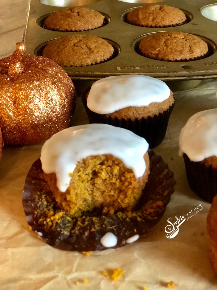 Glazed Pumpkin Spice Muffins combine pumpkin puree and pumpkin pie spice for moist muffins bursting with warm seasonal spices topped with a sweet sugar glaze. An easy recipe made with just a few basic ingredients make this Pumpkin Spice Muffin recipe your new go-to favorite recipe. Perfect for breakfast, as a sweet snack or even for dessert! #pumpkinspice #pumpkinpiespice # pumpkinrecipes #muffins #homemade #baking #breakfast #brunch #dessert #easyrecipe #pumpkinmuffins #swirlsofflavor
