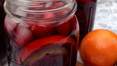 mason mugs with cranberry sangria and cinnamon sticks