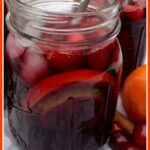 holiday sangria with cranberry juice in mason jar with text overlay