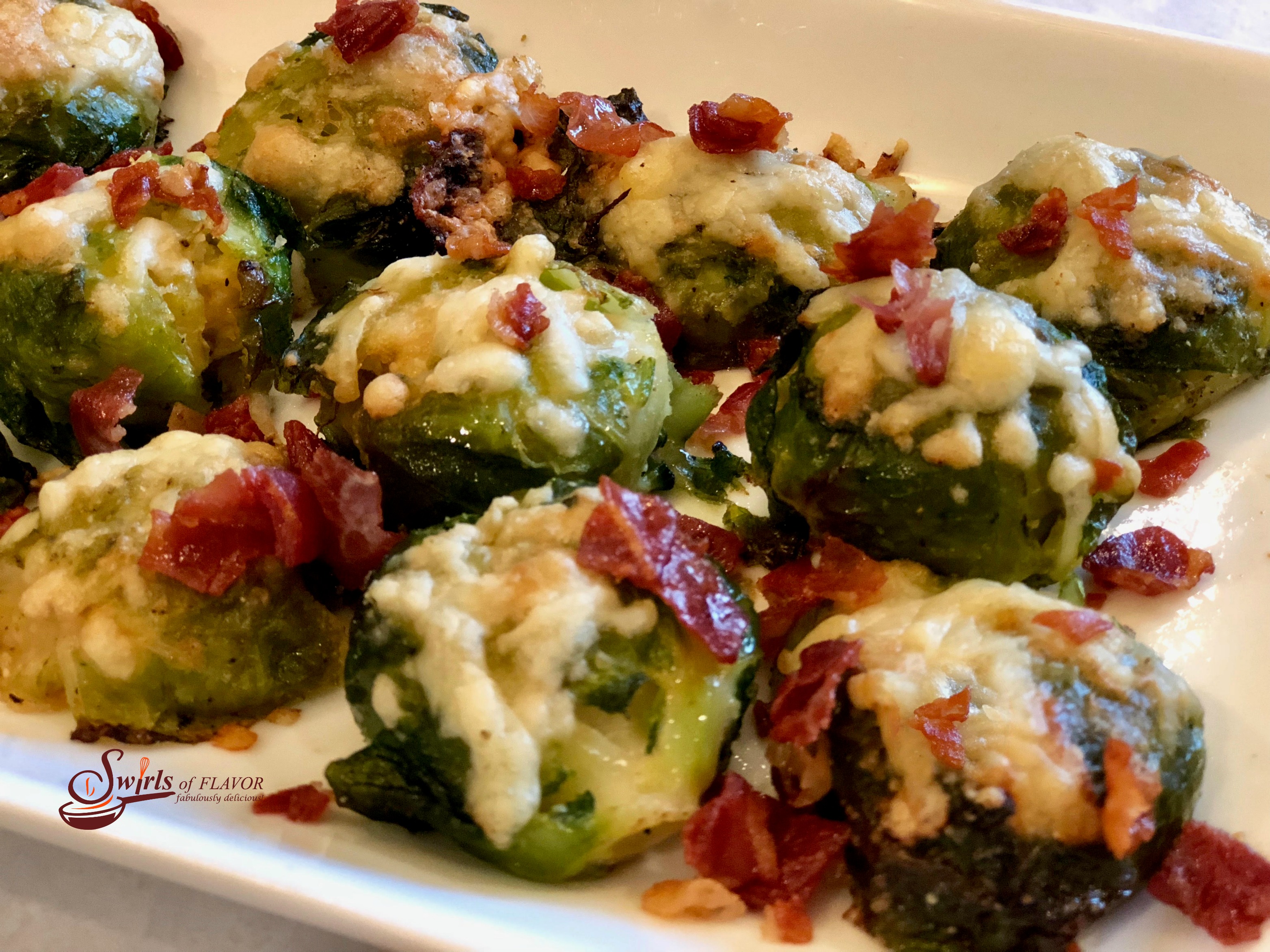 Smashed Brussels Sprouts With Crispy Prosciutto on a white platter
