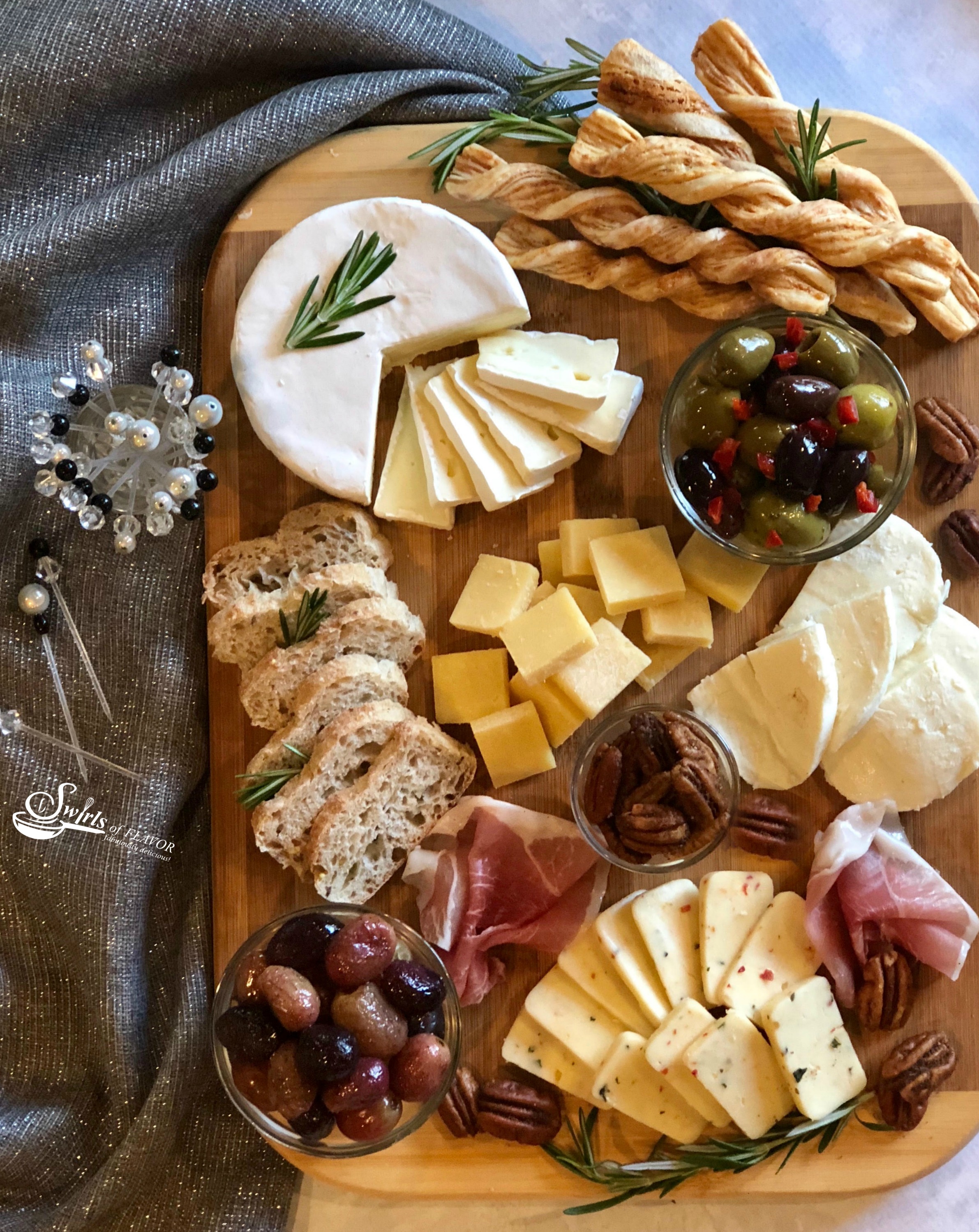 A Holiday Cheese Board with roasted grapes and spiced pecans