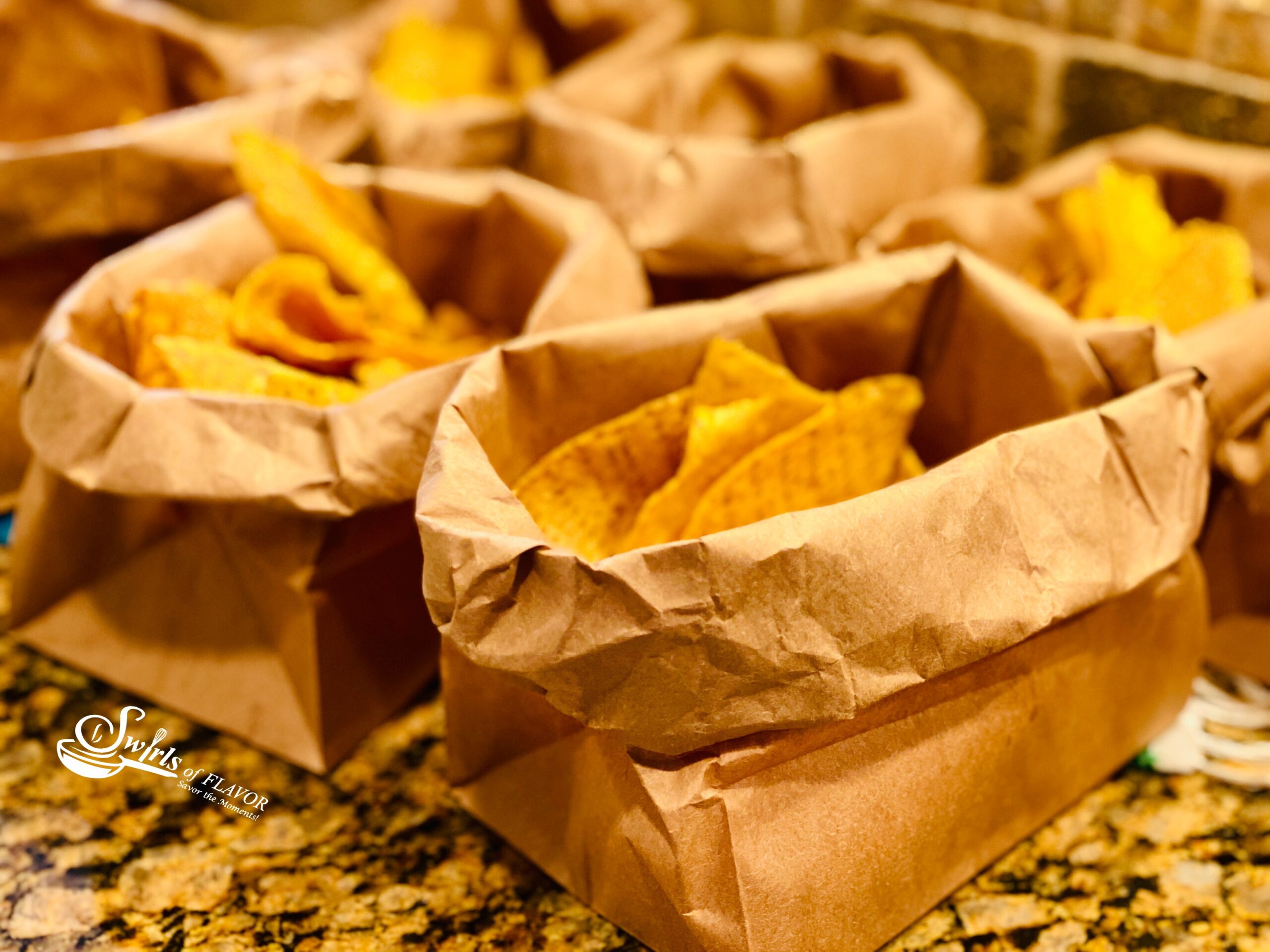 tortilla chips served in brown paper bags