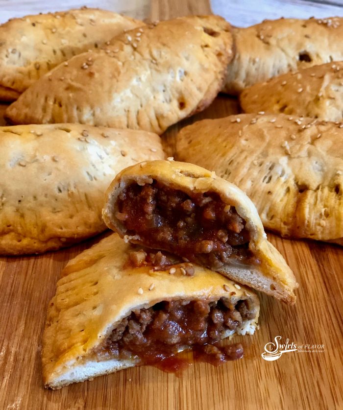 Tender biscuits filled with a saucy Sloppy Joe filling make Sloppy Joe Pockets a delicious on-the-go snack, fun for kids lunch or game day food for your Super Bowl party! An easy homemade Sloppy Joe filling makes every bite of these portable pockets ever so tasty!Â #sloppyjoe #homemadesloppyjoe #funforkids #gamedayfood #handhaldpockets #easyrecipe #superbowl #onthegofood #groundbeef #swirlsofflavor