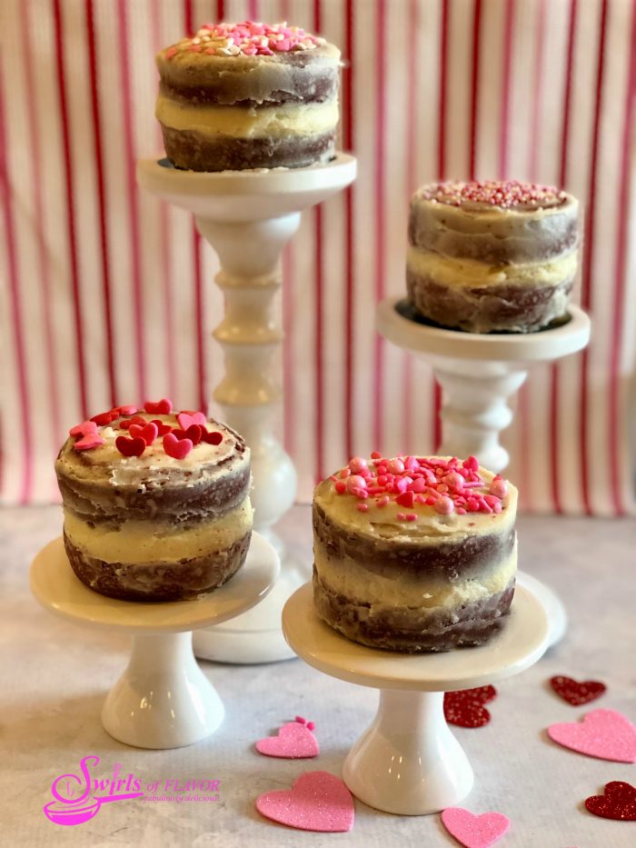 Our Red Velvet Mini Layer Cakes is an easy from scratch cake recipe for your Valentine's Day dessert. Our mini homemade cake layers have a deep intense red color and are flavored with cocoa powder for a delicious chocolate flavor. Red Velvet Mini Layer Cakes are perfect for sharing on Valentine's Day. #redvelvet #valentinesday #valentinesdessert #minilayercake #minilayercakes #redvelvetcake #dessertfortwo #swirlsofflavor