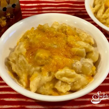 macaroni and cheese shell pasta in a white bowl