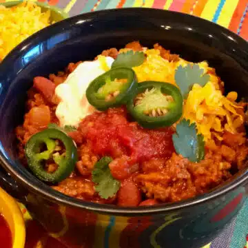bowl of beef chili with beans and toppings
