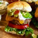 Jalapeno Cheddar Sliders is an easy recipe for mini ground beef burgers that are packed with the flavors of pickled jalapenos, scallions, garlic and spices and topped with a Cilantro Lime Aioli.