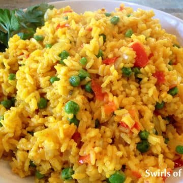 saffron rice with vegetables in a white bowl