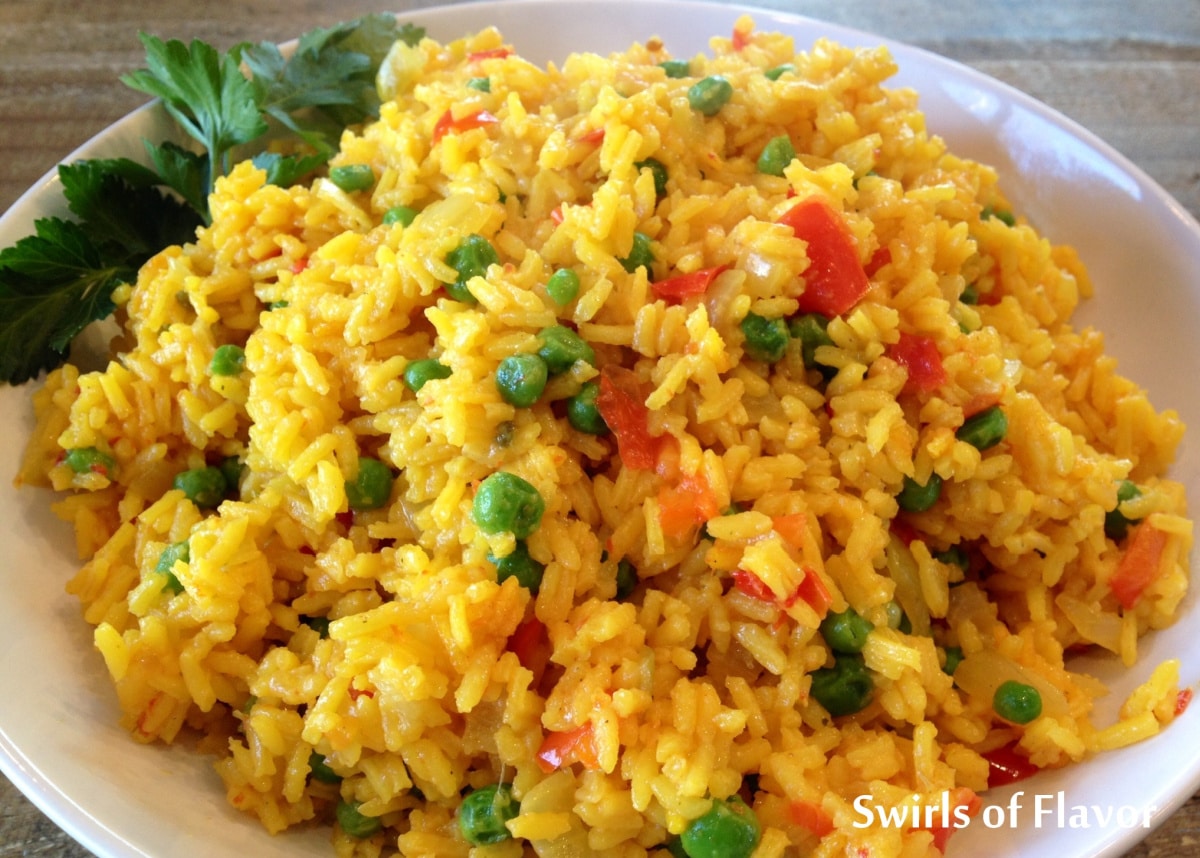 saffron rice with vegetables in a white bowl