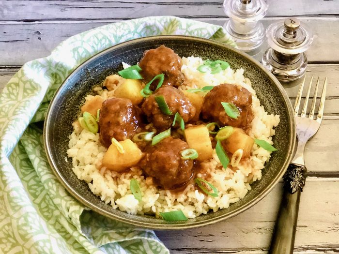 Sweet and Sour Meatballs is an easy recipe for mini meatballs flavored with fresh ginger, cilantro, scallions and garlic, shaped into mini meatballs and simmered in a homemade sweet and sour sauce.