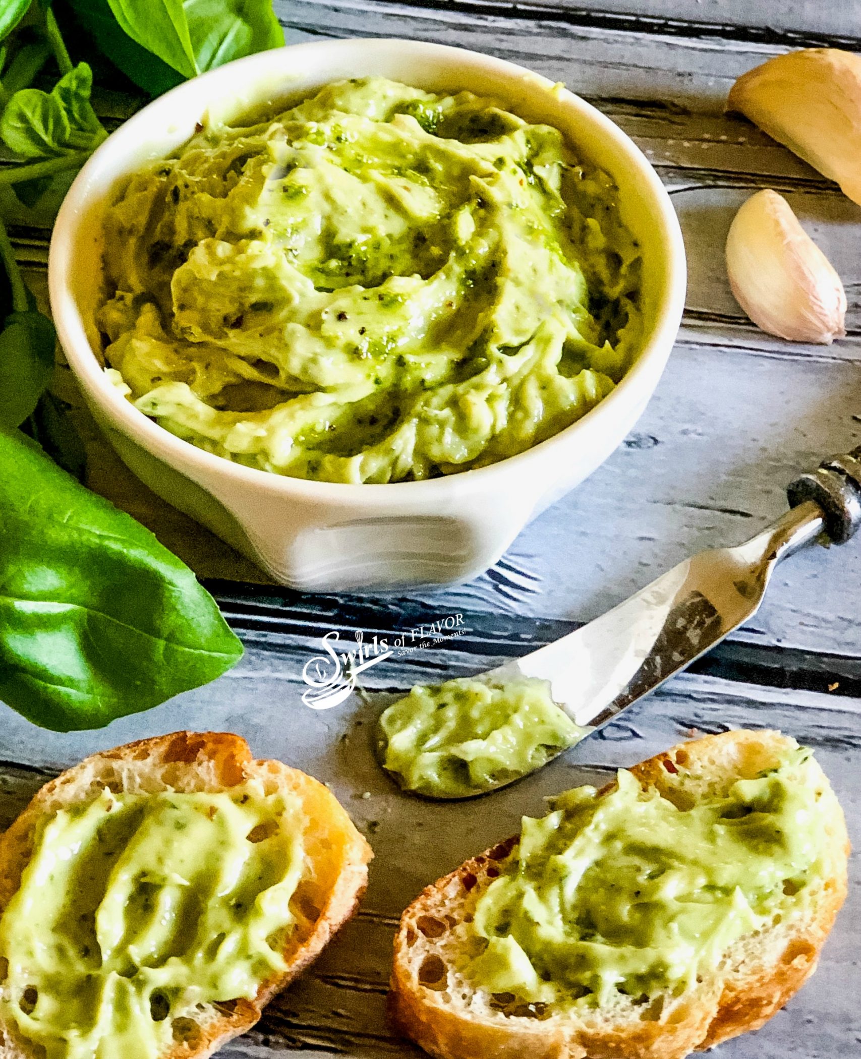 Basil Pesto Butter with knife and spread on bread