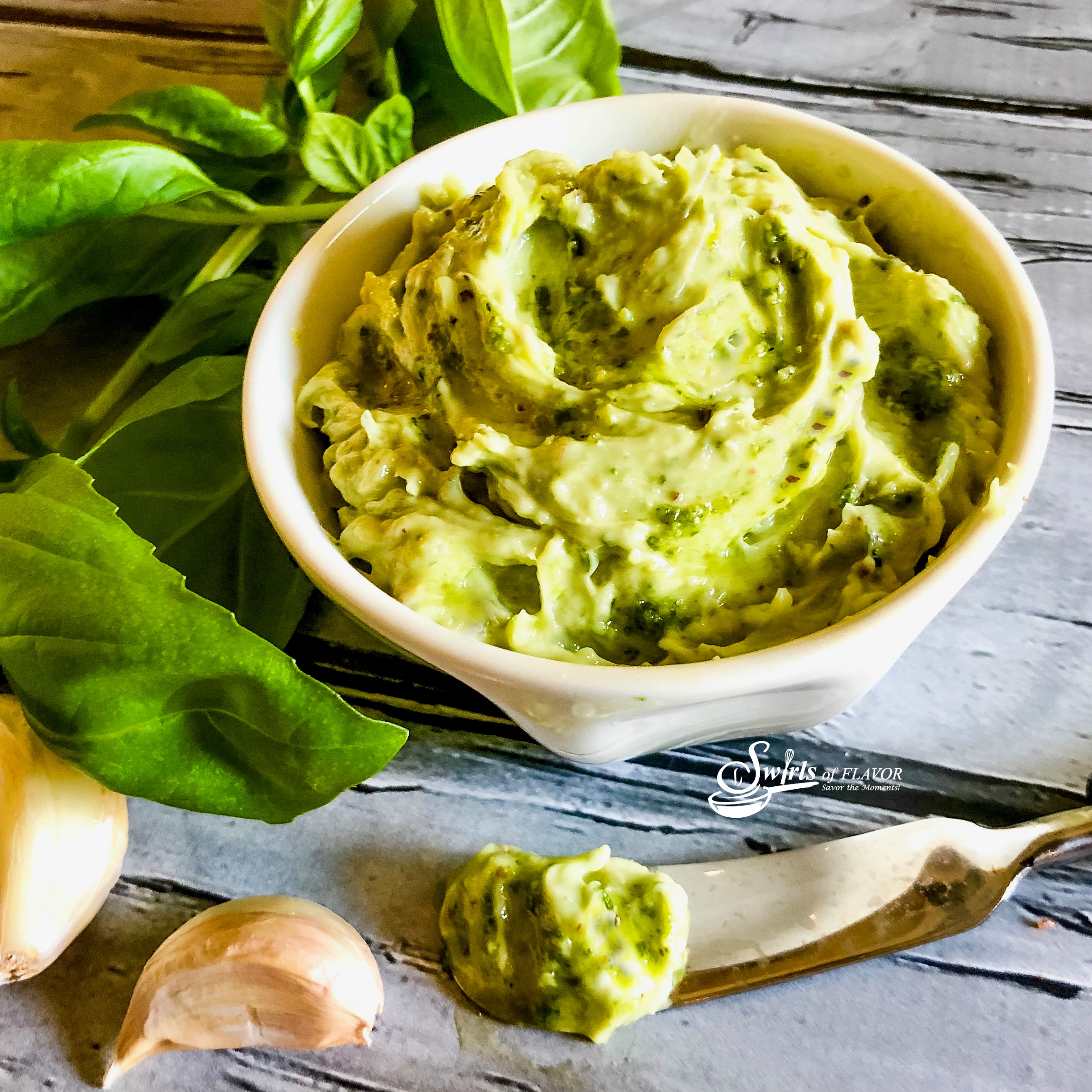 Basil Pesto Butter in bowl with fresh basil