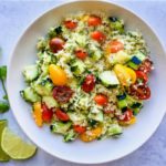 bowl of cauliflower rice salad with fresh vegetables