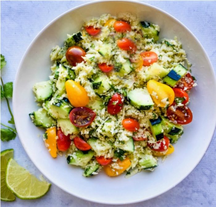 bowl of cauliflower rice salad with fresh vegetables