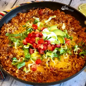 taco beef and rice in skillet with toppings