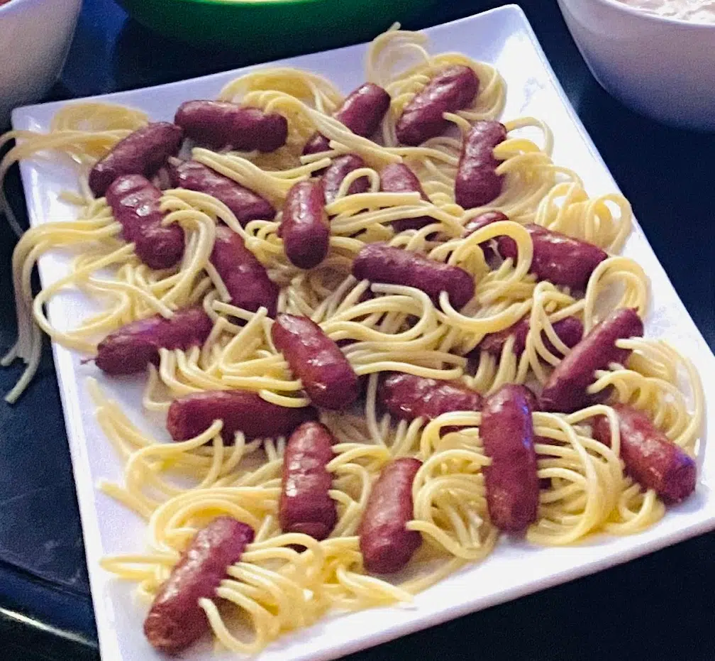 mini hot dog spaghetti spiders on a white platter
