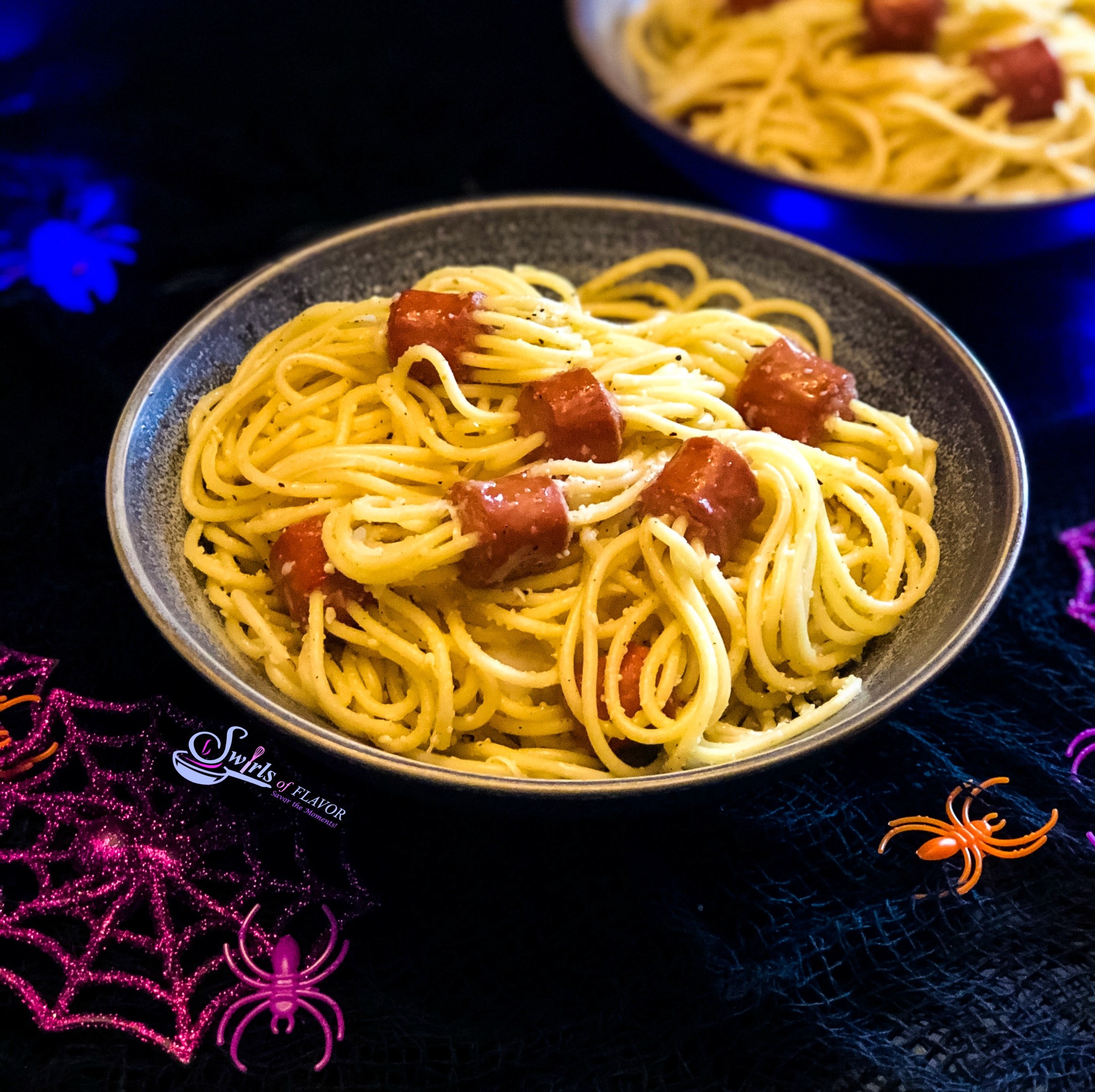 Spaghetti Spider Pasta in dark bowl with plastic spider docorations