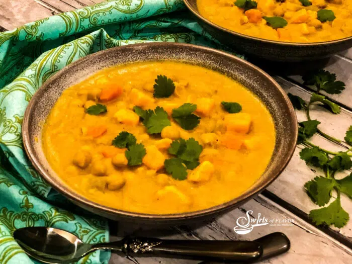 sweet potato soup with chickpeas and green print napkin
