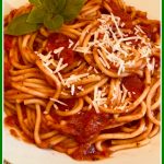 spaghetti with tomato sauce and text overlay