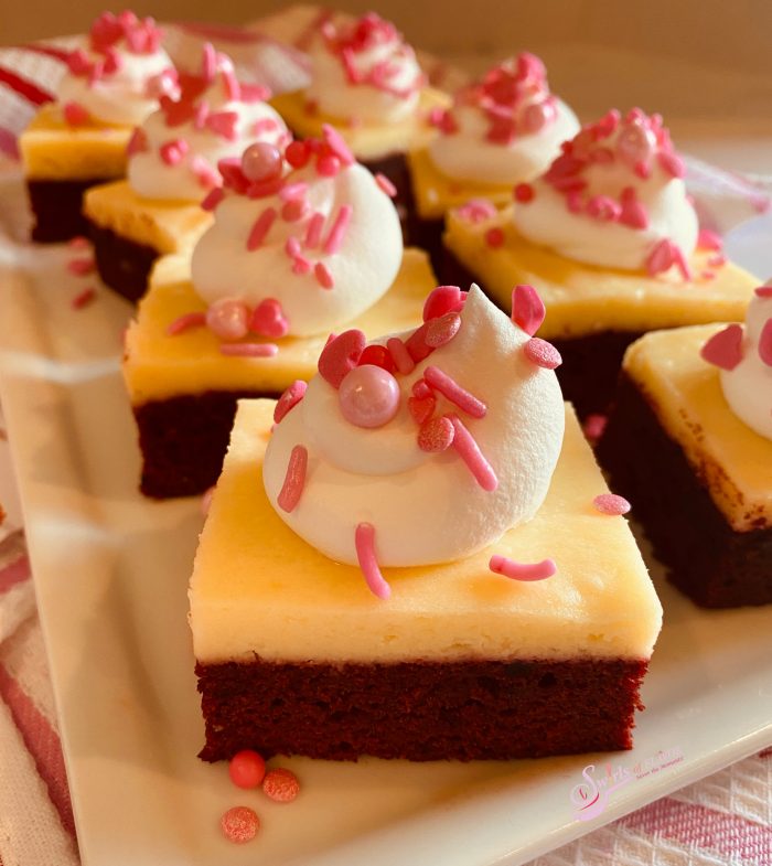 red velvet brownies with whipped topping and sprinkles
