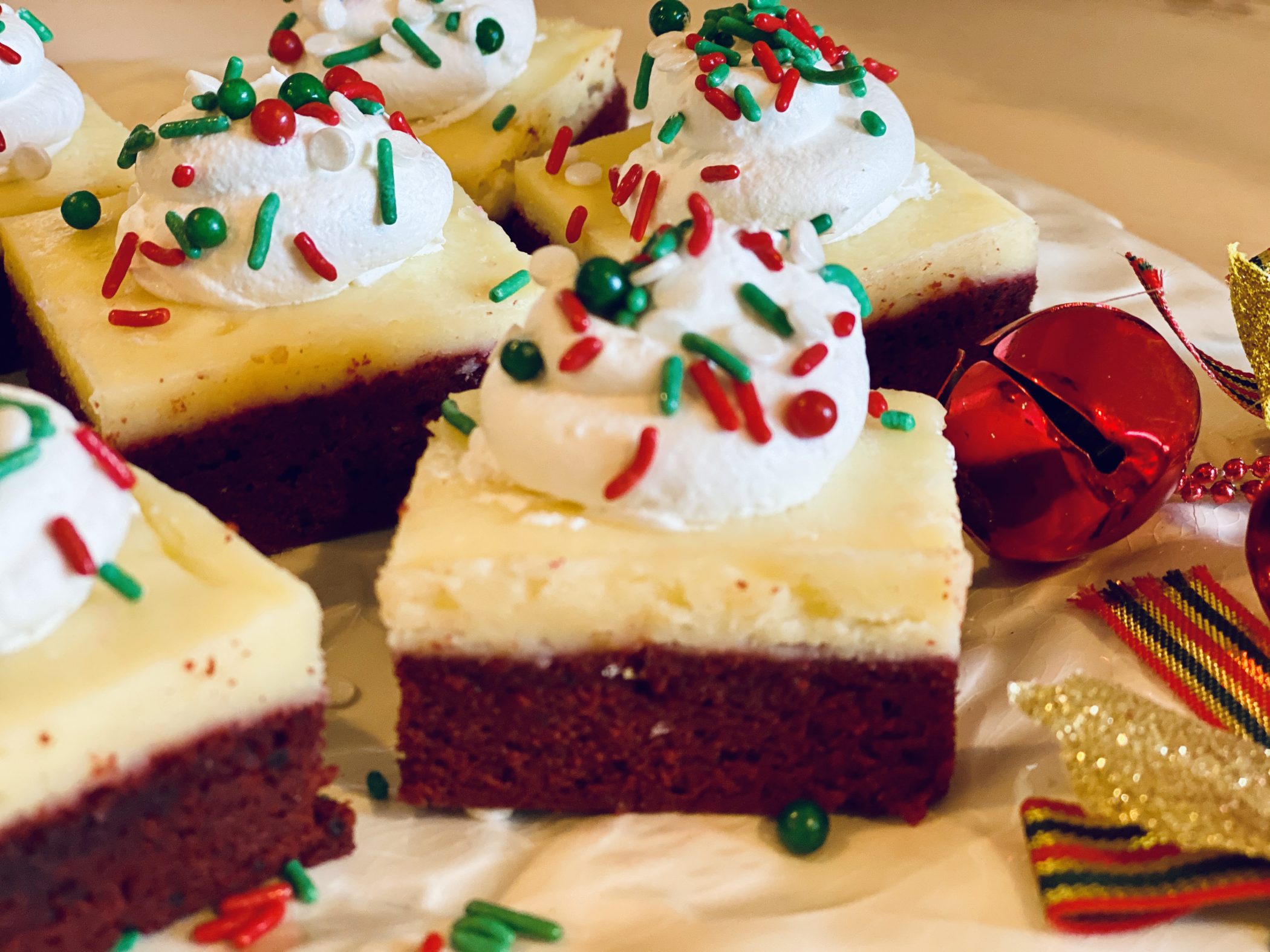 red velvet cheesecake brownies with holiday sprinkles