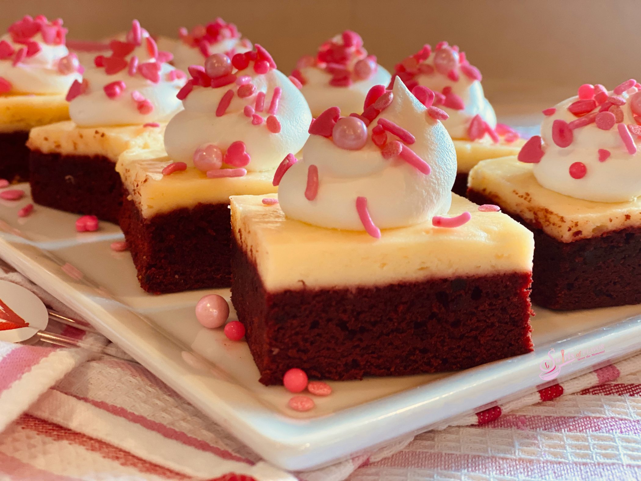 Red Velvet Cheesecake Brownies on white platter