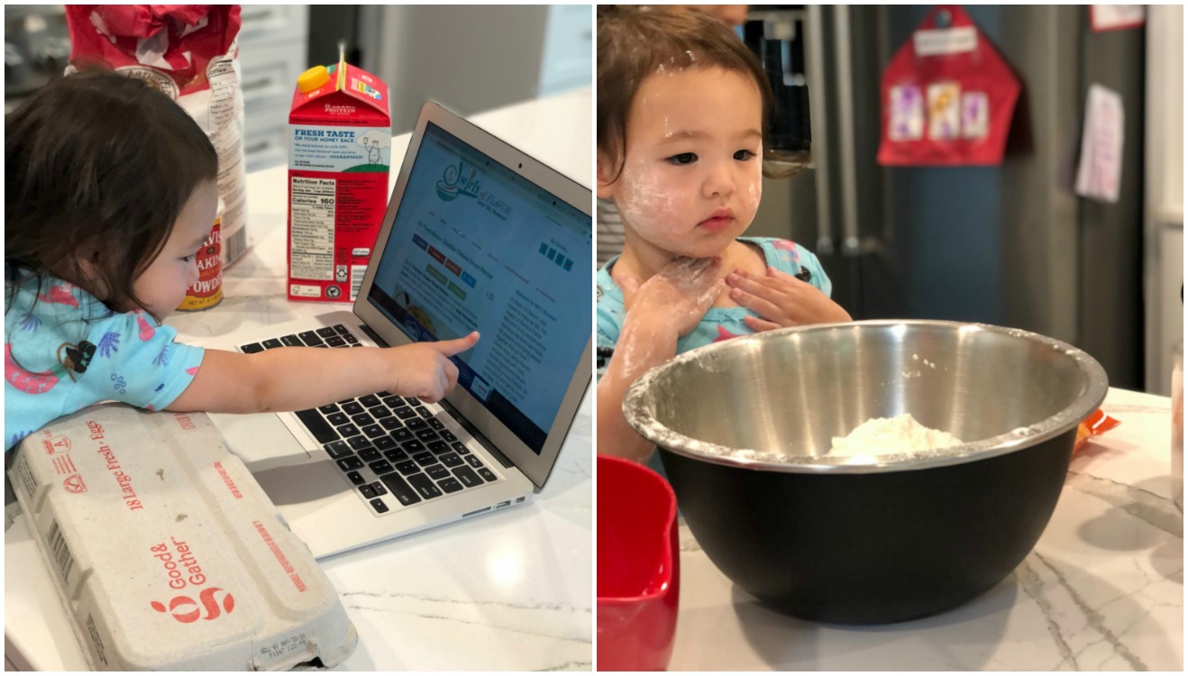 Little girl looking at computer and little girl with flour on her face and bowl of flour