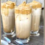 3 glasses d Dalgona whipped iced coffee with spoons