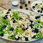 Barley Salad with blueberries on a white oval platter
