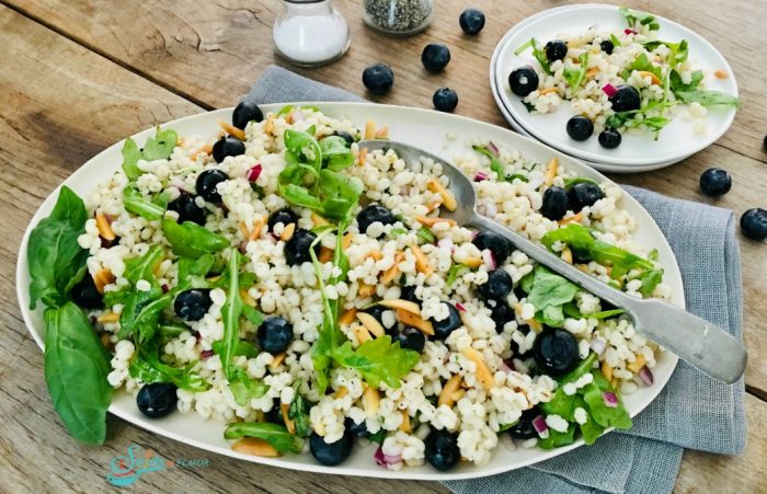 Barley Salad with blueberries on a white oval platter