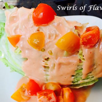 iceberg wedge salad with creamy dressing and tomatoes