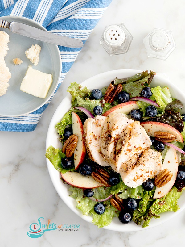 Tossed salad with apples, blueberries, pecans and sliced chicken
