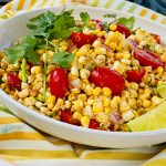 Summer corn salad with tomatoes in white oval dish