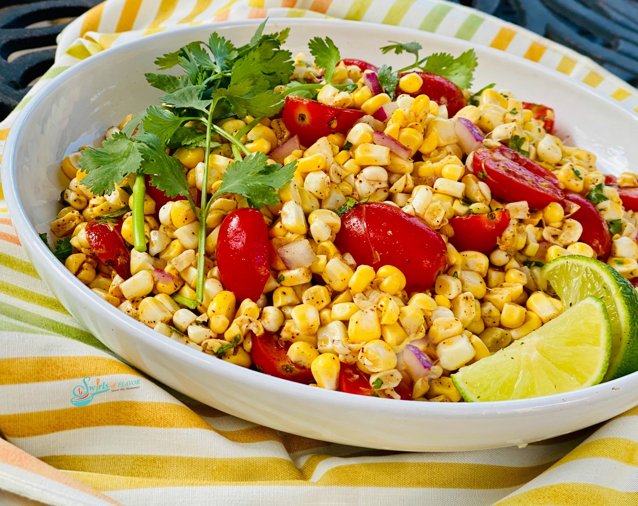 Fresh corn salad with tomatoes in white oval dish