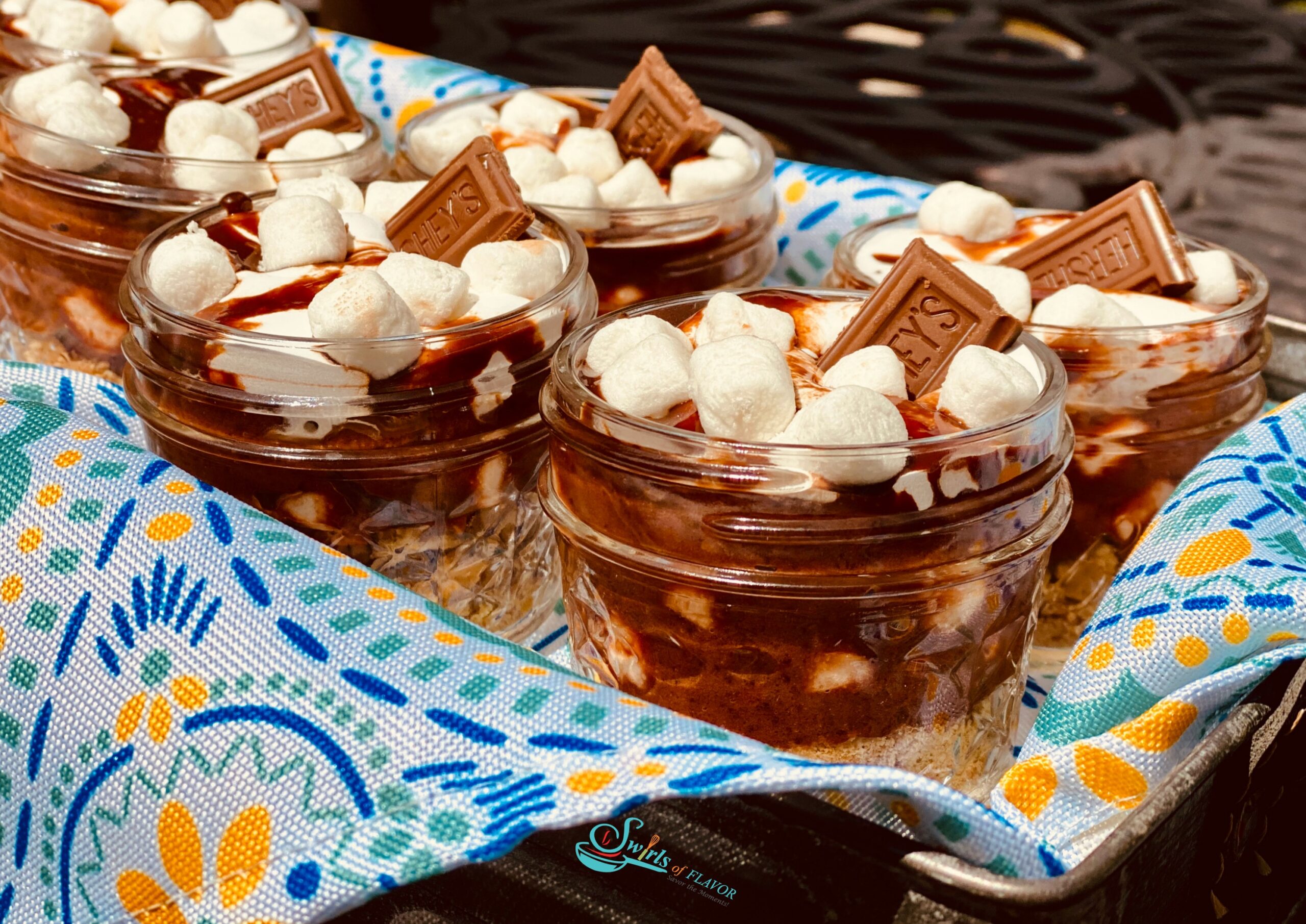 S'mores pudding jars in basket with napkin